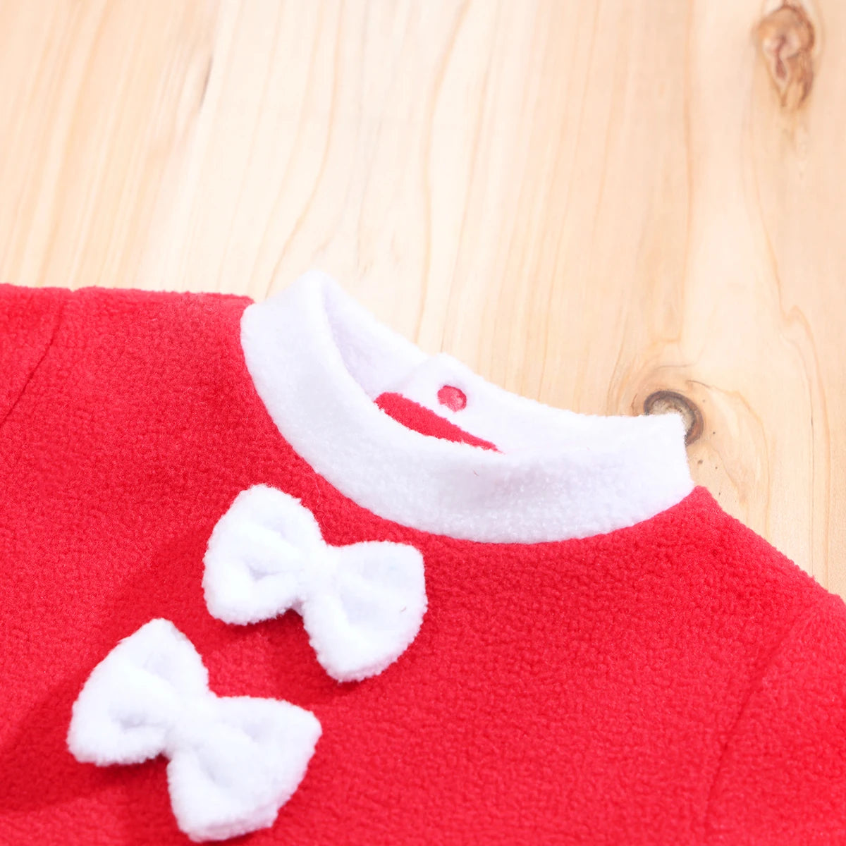 close up of neckline detail on baby christmas dress