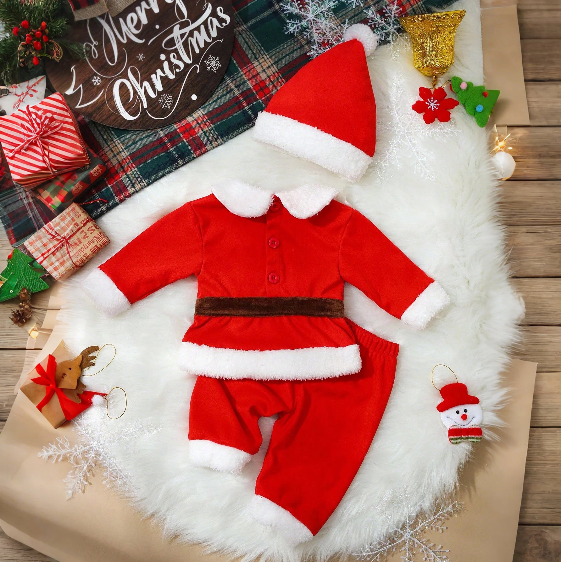 newborn christmas outfit set with hat and romper laid flat on white background